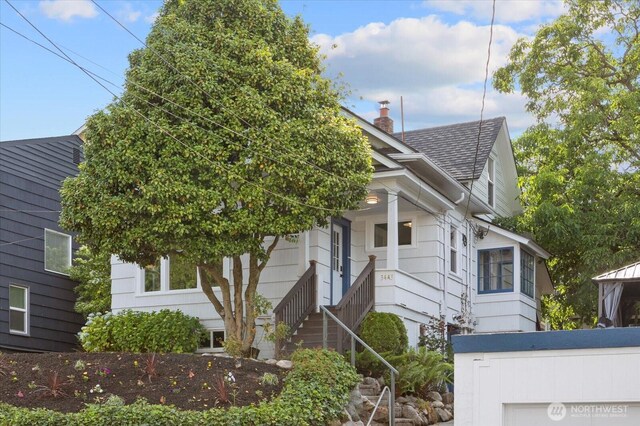 3443 21st Ave W, Seattle, WA 98199 - view of front of home with a chimney, roof with shingles, and stairway