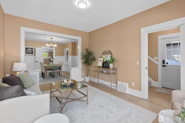 3443 21st Ave W, Seattle, WA 98199 - living room with a chandelier, wood finished floors, and stairway