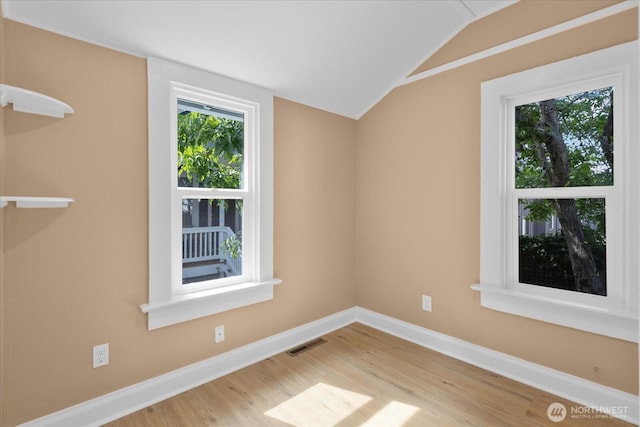 3443 21st Ave W, Seattle, WA 98199 - unfurnished room featuring lofted ceiling and wood finished floors