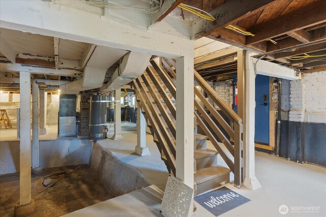 3443 21st Ave W, Seattle, WA 98199 - unfinished basement featuring strapped water heater and stairs