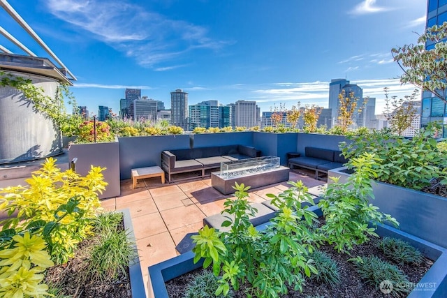2033 2nd Ave Unit 1608, Seattle, WA 98121 - view of patio with an outdoor living space with a fire pit and a view of skyline