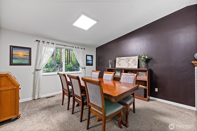 856 Island Blvd, Fox Island, WA 98333 - dining area featuring carpet flooring and vaulted ceiling