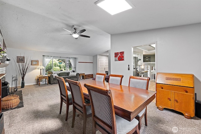 856 Island Blvd, Fox Island, WA 98333 - dining space with a ceiling fan, light colored carpet, and vaulted ceiling