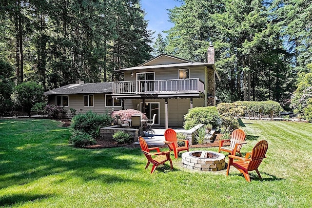 856 Island Blvd, Fox Island, WA 98333 - back of property with an outdoor fire pit, a chimney, a patio, a yard, and a deck