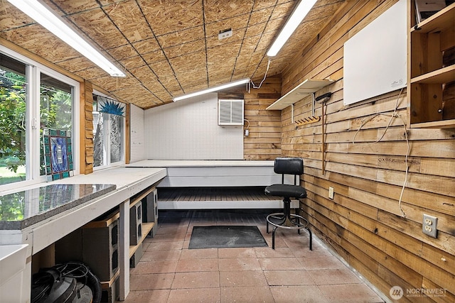 856 Island Blvd, Fox Island, WA 98333 - misc room with wooden walls, vaulted ceiling, stone tile floors, and a wall mounted AC