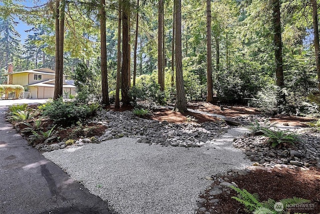 856 Island Blvd, Fox Island, WA 98333 - view of yard with an attached garage and driveway