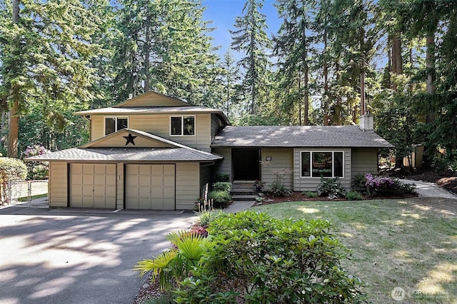 856 Island Blvd, Fox Island, WA 98333 - split level home featuring a garage, a chimney, a shingled roof, and asphalt driveway