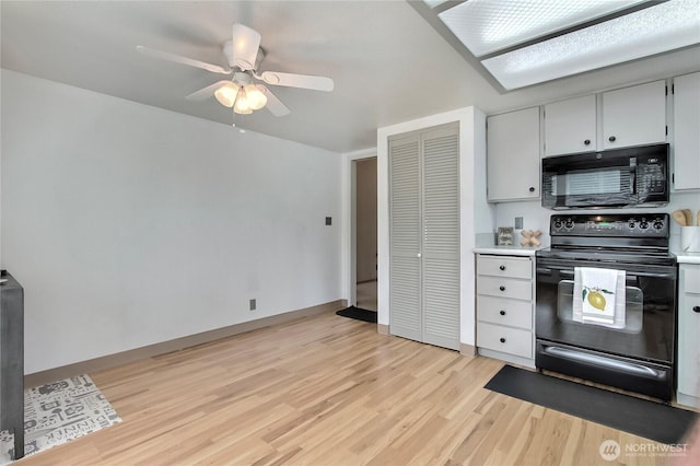 33615 30th Ave SW, Federal Way, WA 98023 - kitchen with black appliances, light wood finished floors, light countertops, and ceiling fan