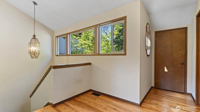 9623 NE Riverbend Dr Unit 2B, Bothell, WA 98011 - entrance foyer with vaulted ceiling, light wood-style floors, and a chandelier