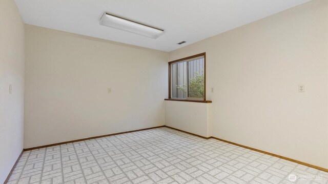 9623 NE Riverbend Dr Unit 2B, Bothell, WA 98011 - unfurnished room with baseboards and brick patterned floors