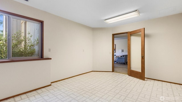 9623 NE Riverbend Dr Unit 2B, Bothell, WA 98011 - spare room featuring baseboards and brick patterned floors