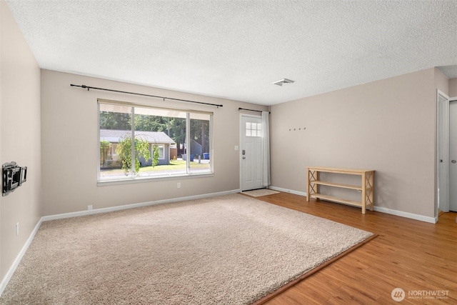 19436 SE 266th St, Covington, WA 98042 - foyer with a textured ceiling and wood finished floors