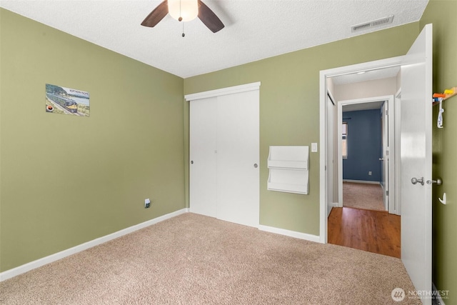 19436 SE 266th St, Covington, WA 98042 - unfurnished bedroom featuring carpet, a closet, a textured ceiling, and a ceiling fan
