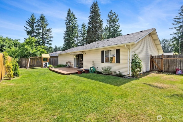 19436 SE 266th St, Covington, WA 98042 - back of property with a deck, a fenced backyard, a shingled roof, and a playground