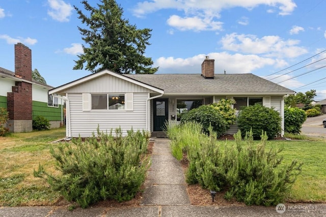 5142 N 27th St, Tacoma, WA 98407 - view of front facade featuring a front yard, a chimney, and roof with shingles