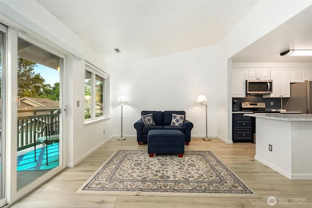 901 E Marine View Dr Unit 206, Everett, WA 98201 - living area featuring light wood-style floors and baseboards