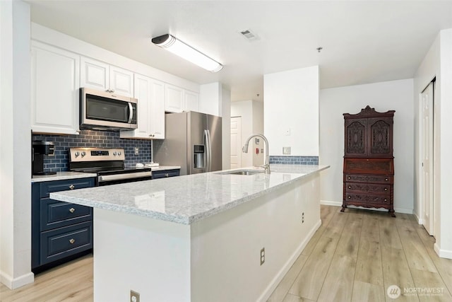 901 E Marine View Dr Unit 206, Everett, WA 98201 - kitchen with appliances with stainless steel finishes, light wood-type flooring, and white cabinetry