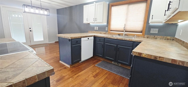 5903 187th Ave SW, Rochester, WA 98579 - kitchen featuring dishwasher, light wood finished floors, white cabinets, a peninsula, and hanging light fixtures