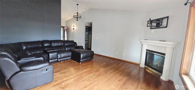 5903 187th Ave SW, Rochester, WA 98579 - living area featuring vaulted ceiling, wood-type flooring, and a glass covered fireplace