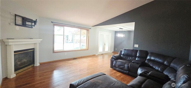 5903 187th Ave SW, Rochester, WA 98579 - living area with wood finished floors, vaulted ceiling, and a glass covered fireplace