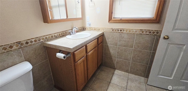 5903 187th Ave SW, Rochester, WA 98579 - bathroom featuring tile walls, vanity, a wainscoted wall, and tile patterned flooring