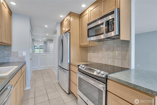 762 Hayes St Unit 17, Seattle, WA 98109 - kitchen featuring appliances with stainless steel finishes, decorative backsplash, light brown cabinets, light tile patterned floors, and recessed lighting