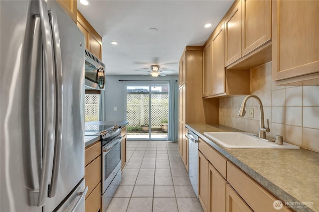 762 Hayes St Unit 17, Seattle, WA 98109 - kitchen with appliances with stainless steel finishes, a ceiling fan, light tile patterned floors, recessed lighting, and tasteful backsplash