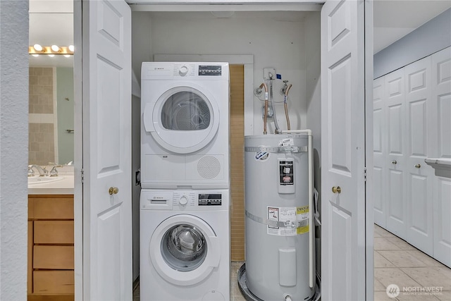 762 Hayes St Unit 17, Seattle, WA 98109 - washroom featuring water heater, stacked washer / drying machine, and light tile patterned floors