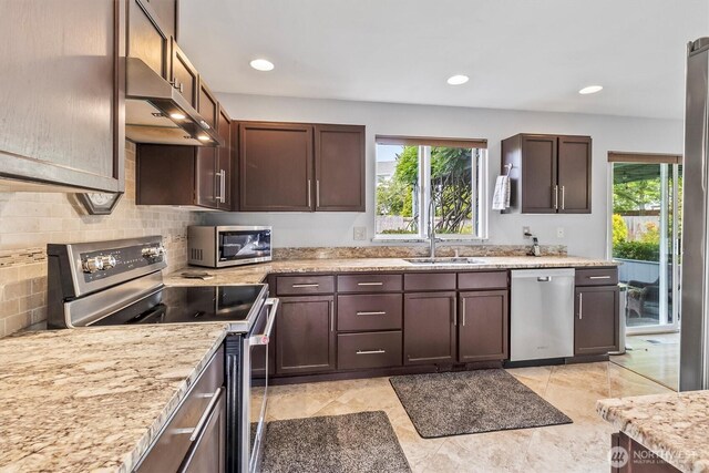 1606 94th Ave NE, Lake Stevens, WA 98258 - kitchen with appliances with stainless steel finishes, plenty of natural light, ventilation hood, tasteful backsplash, and recessed lighting