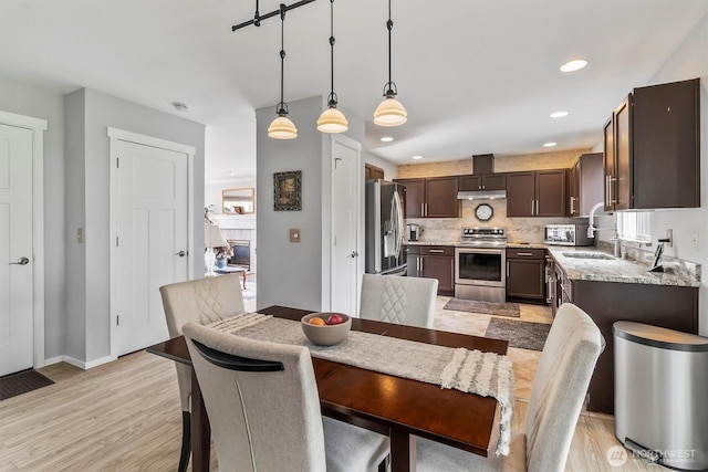 1606 94th Ave NE, Lake Stevens, WA 98258 - dining room with light wood-style floors, a fireplace, and recessed lighting