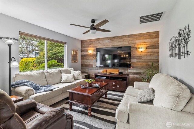 1606 94th Ave NE, Lake Stevens, WA 98258 - living area featuring wooden walls, an accent wall, and a ceiling fan