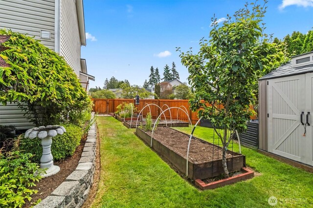 1606 94th Ave NE, Lake Stevens, WA 98258 - fenced backyard featuring a vegetable garden and a storage unit