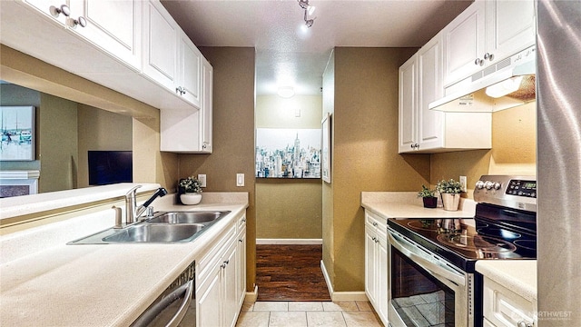 23301 Cedar Way Unit U102, Mountlake Terrace, WA 98043 - kitchen with stainless steel electric range oven, under cabinet range hood, light countertops, and white cabinetry