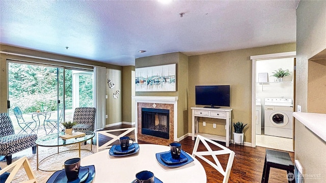 23301 Cedar Way Unit U102, Mountlake Terrace, WA 98043 - living room featuring washing machine and dryer, dark wood finished floors, a tile fireplace, and a textured ceiling
