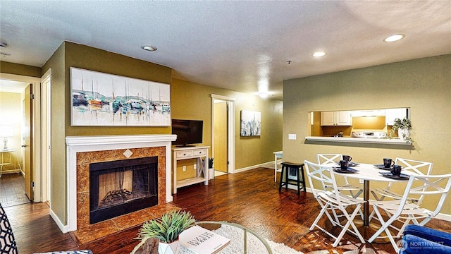 23301 Cedar Way Unit U102, Mountlake Terrace, WA 98043 - living room with dark wood-type flooring, recessed lighting, and a tiled fireplace