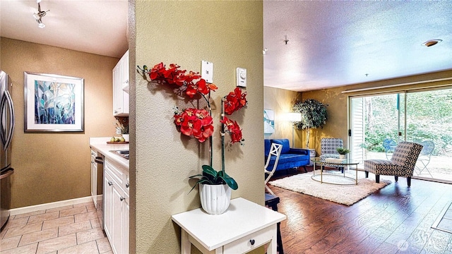 23301 Cedar Way Unit U102, Mountlake Terrace, WA 98043 - interior space featuring a textured wall and light wood-style floors