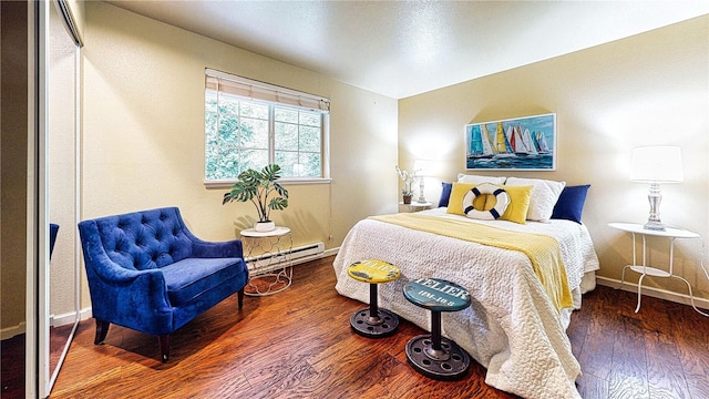 23301 Cedar Way Unit U102, Mountlake Terrace, WA 98043 - bedroom with a baseboard heating unit and wood finished floors