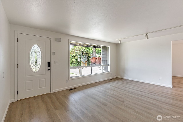 12124 SE 161st St, Renton, WA 98058 - foyer featuring light wood finished floors and a textured ceiling