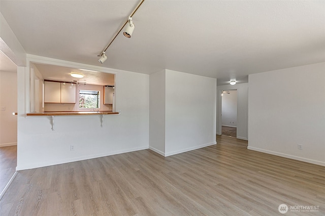 12124 SE 161st St, Renton, WA 98058 - unfurnished living room featuring light wood finished floors and track lighting
