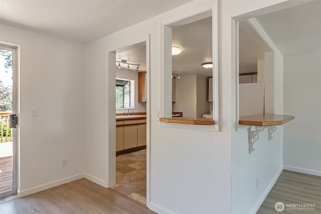 12124 SE 161st St, Renton, WA 98058 - kitchen with light wood finished floors, a textured ceiling, and track lighting