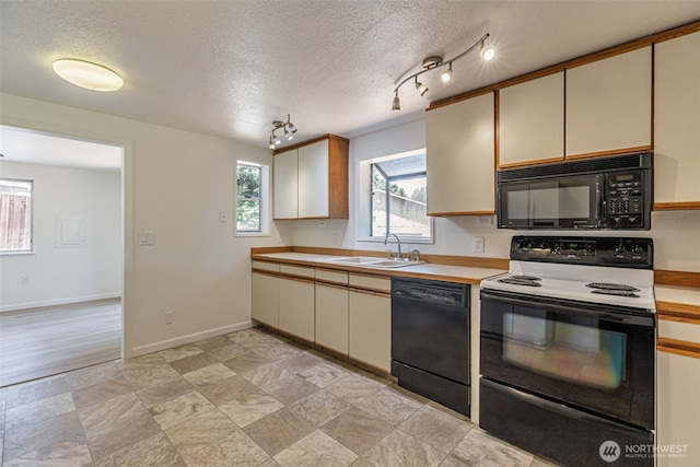 12124 SE 161st St, Renton, WA 98058 - kitchen featuring black appliances, light countertops, a textured ceiling, and cream cabinetry