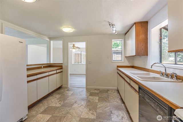 12124 SE 161st St, Renton, WA 98058 - kitchen featuring freestanding refrigerator, black dishwasher, a textured ceiling, light countertops, and light stone finish floors
