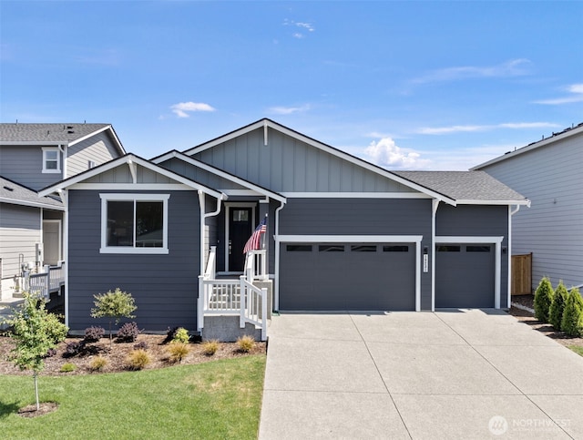 18231 132nd Ave E, Puyallup, WA 98374 - view of front of home featuring an attached garage, driveway, a front lawn, and board and batten siding