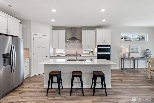 18231 132nd Ave E, Puyallup, WA 98374 - kitchen with stainless steel refrigerator with ice dispenser, wall chimney exhaust hood, light countertops, tasteful backsplash, and recessed lighting