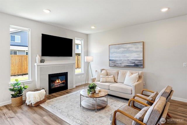 18231 132nd Ave E, Puyallup, WA 98374 - living area with wood finished floors, a tiled fireplace, plenty of natural light, and recessed lighting