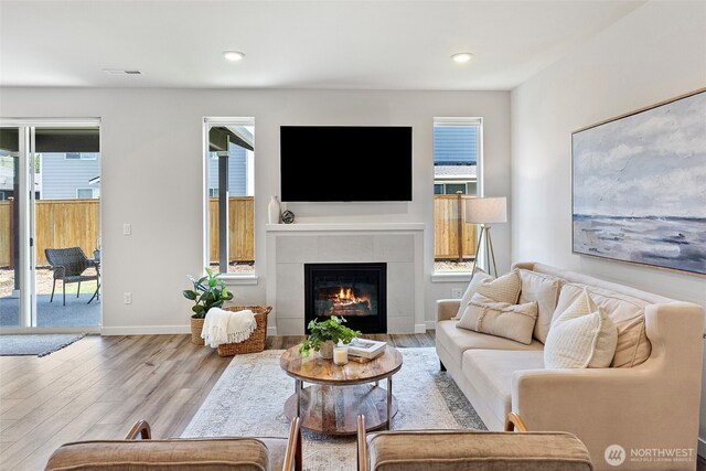 18231 132nd Ave E, Puyallup, WA 98374 - living area with wood finished floors, a tiled fireplace, and recessed lighting
