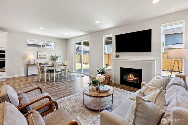 18231 132nd Ave E, Puyallup, WA 98374 - living room with a tile fireplace, wood finished floors, and recessed lighting