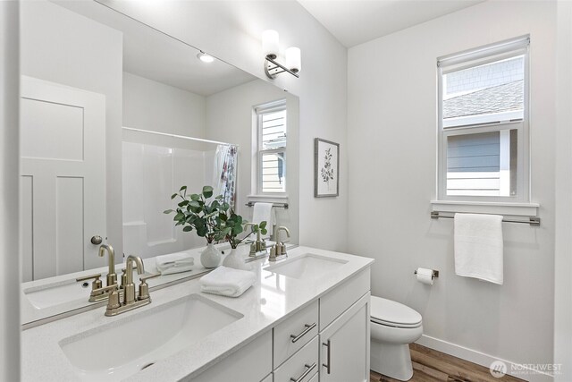 18231 132nd Ave E, Puyallup, WA 98374 - full bath with double vanity, wood finished floors, and a shower with curtain