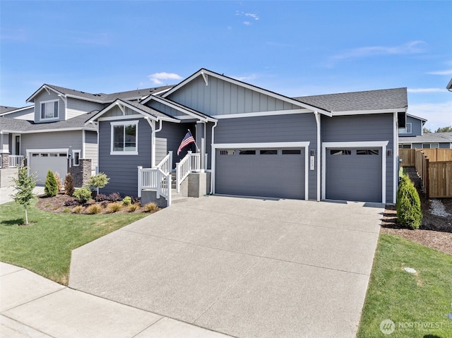 18231 132nd Ave E, Puyallup, WA 98374 - view of front of home featuring a garage, driveway, board and batten siding, and a shingled roof