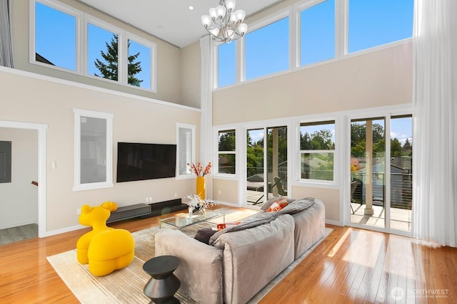 8441 8th Ave SW, Seattle, WA 98106 - living room with a high ceiling, wood finished floors, and a chandelier